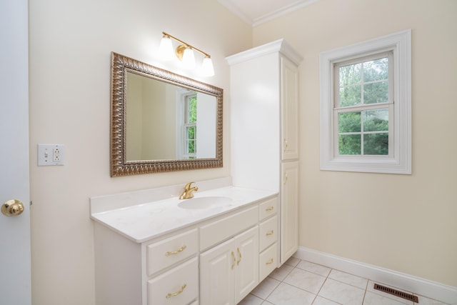 bathroom featuring vanity, baseboards, tile patterned floors, and ornamental molding