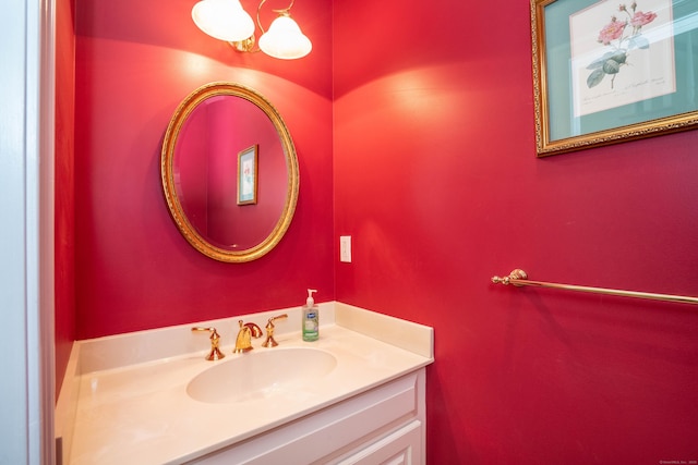 bathroom with vanity and a chandelier