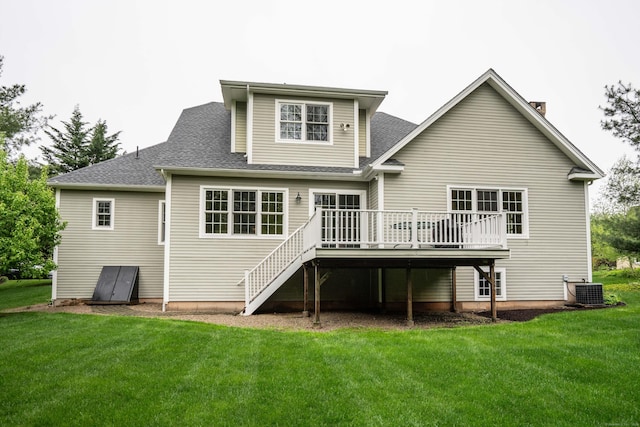 rear view of property with a wooden deck, a yard, a shingled roof, and cooling unit