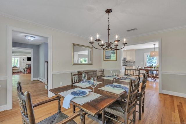 16 Cider Mill Rd, Burlington, CT 06013 - dining space with baseboard heating, a chandelier, healthy amount of natural light, light wood-style floors, and crown molding