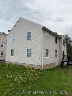 back of property featuring a yard