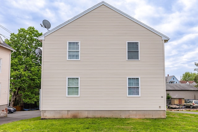view of side of property with a yard