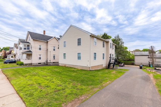 view of side of property with a yard and a residential view