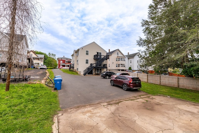 view of asphalt road with stairs and a residential view