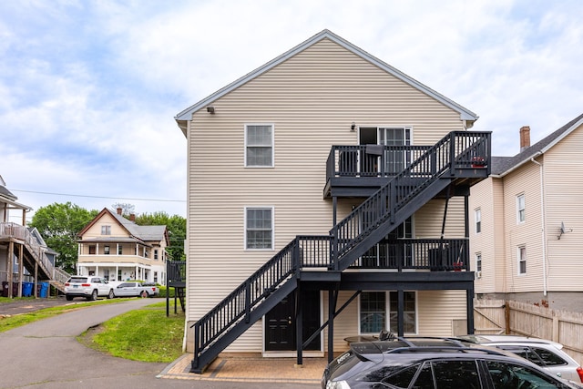 back of property featuring stairs, fence, a wooden deck, and central AC