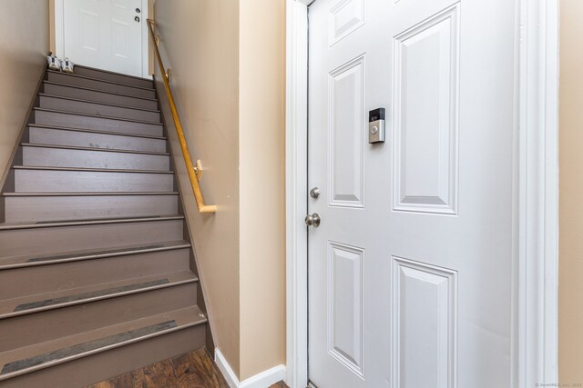 stairs featuring baseboards and wood finished floors