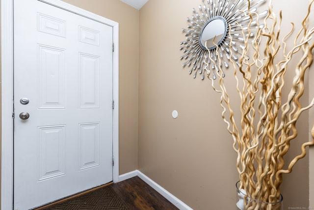 doorway to outside with baseboards and dark wood finished floors