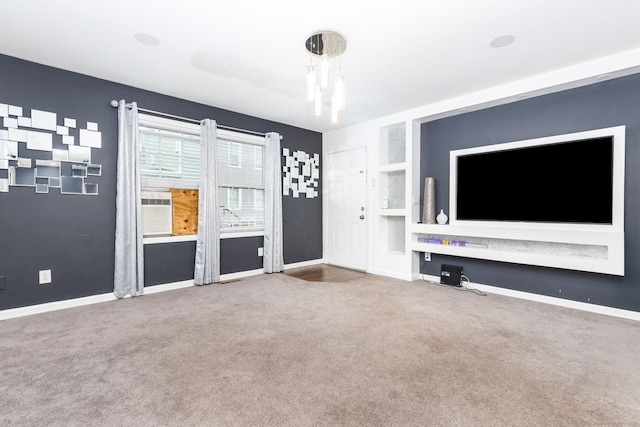 unfurnished living room with carpet, baseboards, and built in features