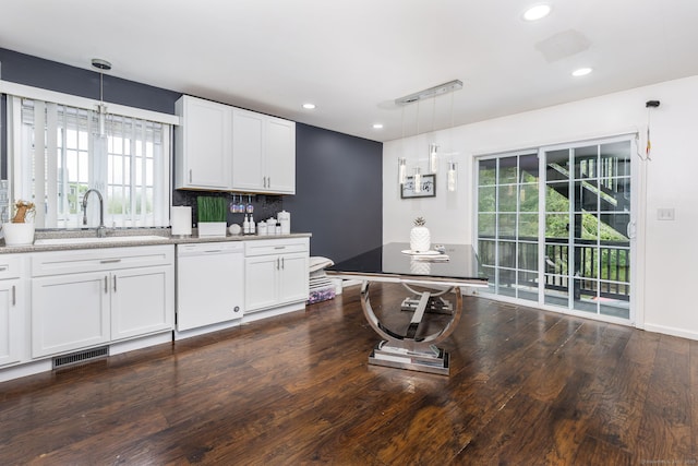 kitchen featuring dishwasher, a sink, dark wood-style flooring, white cabinets, and hanging light fixtures