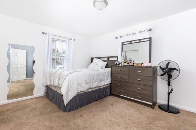 bedroom featuring light colored carpet and baseboards