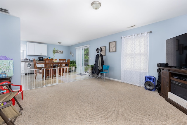 carpeted living area with baseboards