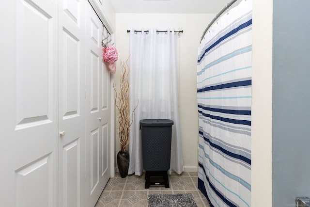 bathroom featuring tile patterned floors and a shower with shower curtain