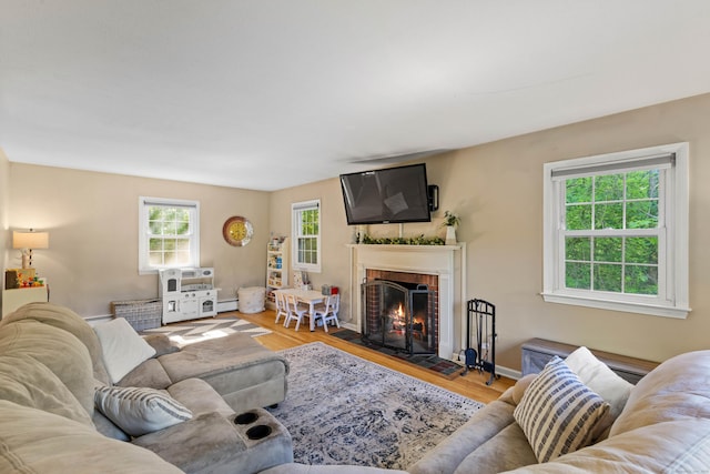 5 Willow Ln, East Lyme, CT 06333 - living room with a fireplace, wood finished floors, a baseboard radiator, and baseboards