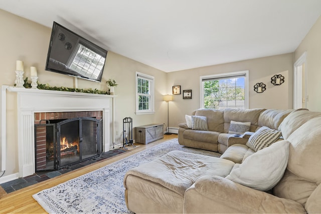 5 Willow Ln, East Lyme, CT 06333 - living room with a brick fireplace, wood finished floors, and baseboard heating