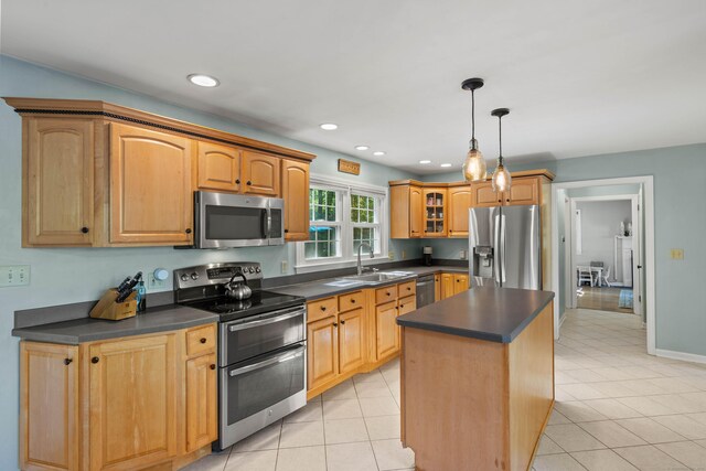 5 Willow Ln, East Lyme, CT 06333 - kitchen with appliances with stainless steel finishes, dark countertops, light tile patterned flooring, a center island, and recessed lighting