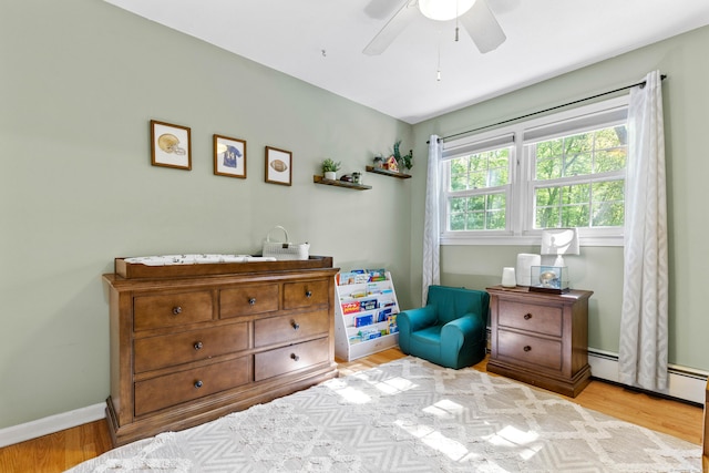 5 Willow Ln, East Lyme, CT 06333 - bedroom featuring baseboard heating, wood finished floors, ceiling fan, and baseboards