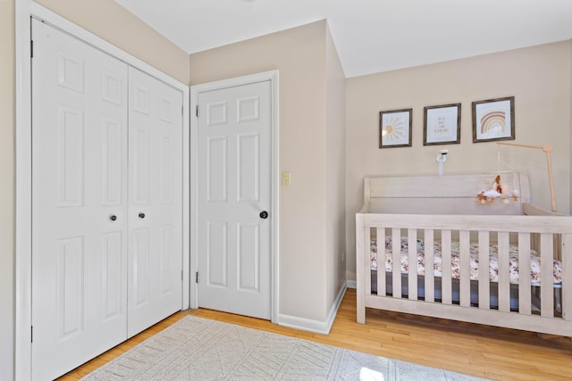5 Willow Ln, East Lyme, CT 06333 - bedroom featuring a closet, wood finished floors, a nursery area, and baseboards