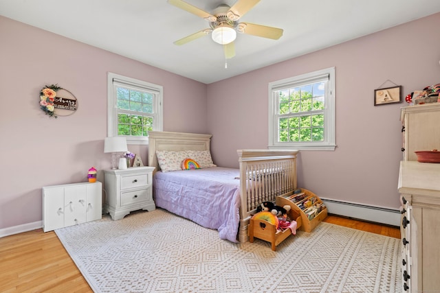 5 Willow Ln, East Lyme, CT 06333 - bedroom with baseboard heating, wood finished floors, and ceiling fan