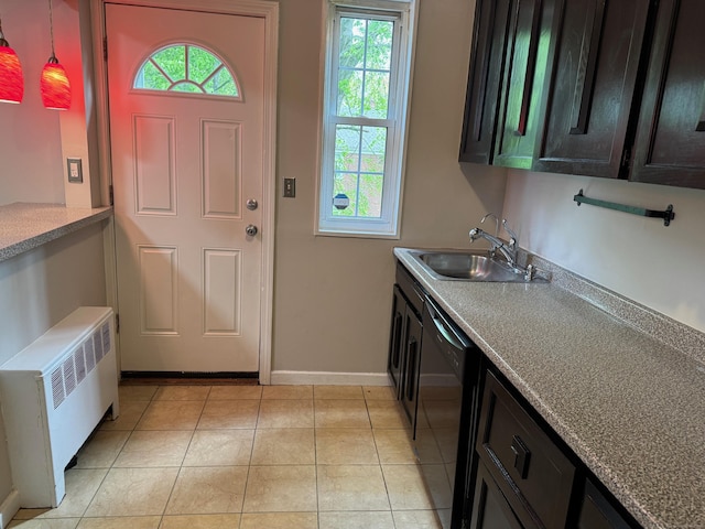 entrance foyer with radiator heating unit, plenty of natural light, baseboards, and light tile patterned flooring