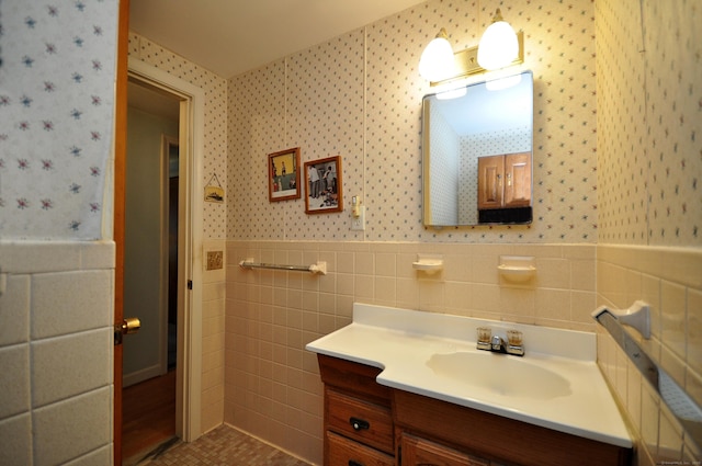 1268 Trout Brook Dr, West Hartford, CT 06119 - bathroom with wallpapered walls, wainscoting, vanity, and tile walls