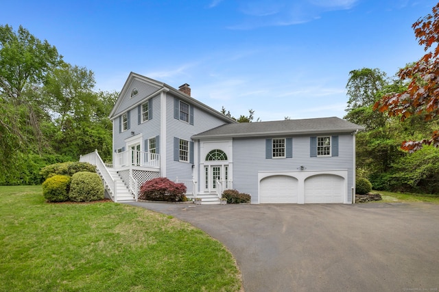 98 Hemlock Valley Rd, East Haddam, CT 06423 - view of front facade with a chimney, a garage, a front yard, asphalt driveway, and stairway