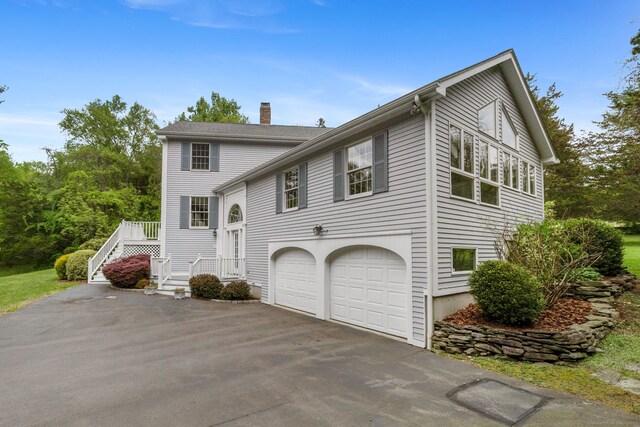 98 Hemlock Valley Rd, East Haddam, CT 06423 - view of front of home featuring a chimney, an attached garage, and driveway