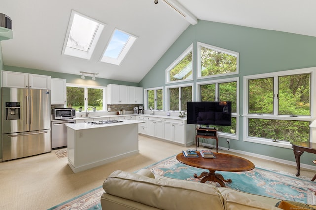 98 Hemlock Valley Rd, East Haddam, CT 06423 - living area featuring a skylight, high vaulted ceiling, and beamed ceiling