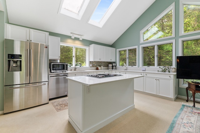 98 Hemlock Valley Rd, East Haddam, CT 06423 - kitchen with appliances with stainless steel finishes, light countertops, white cabinetry, a skylight, and a center island
