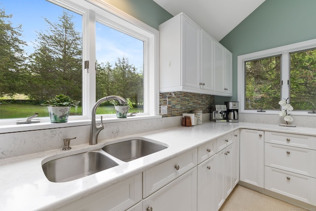 98 Hemlock Valley Rd, East Haddam, CT 06423 - kitchen featuring a sink, vaulted ceiling, white cabinets, and tasteful backsplash