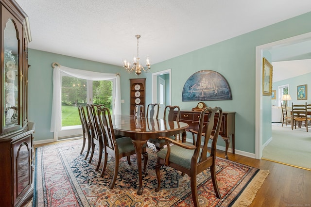 98 Hemlock Valley Rd, East Haddam, CT 06423 - dining room with a chandelier, wood finished floors, and baseboards
