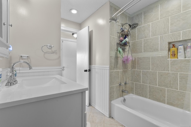 full bath featuring shower / bathtub combination, a wainscoted wall, and vanity