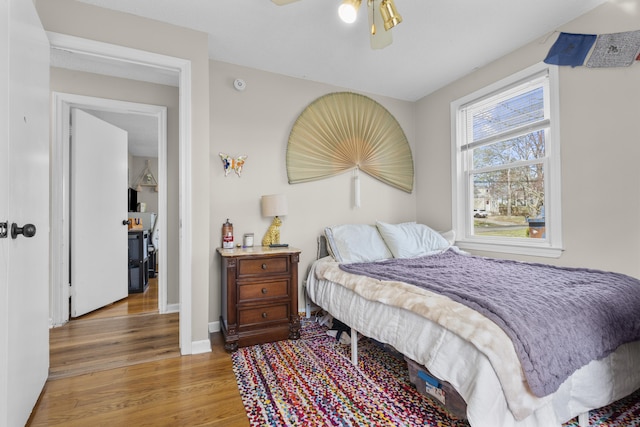 bedroom featuring wood finished floors, ceiling fan, and baseboards