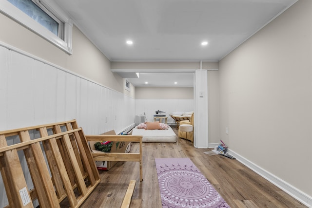 exercise area featuring wood finished floors, a wainscoted wall, and recessed lighting