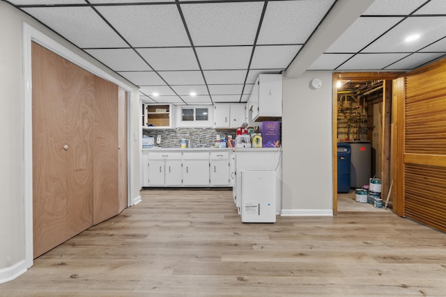 kitchen with white cabinets, water heater, light wood-type flooring, light countertops, and recessed lighting