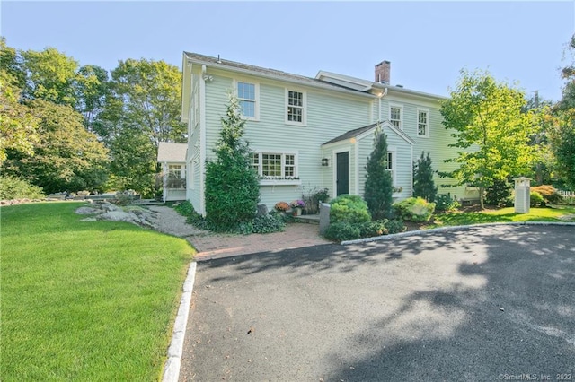 521 State St, Guilford, CT 06437 - view of front of house featuring a chimney and a front lawn