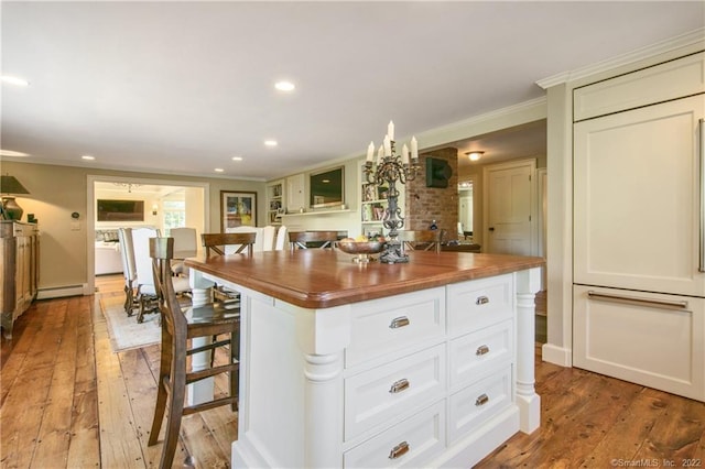 521 State St, Guilford, CT 06437 - kitchen with wood counters, a baseboard radiator, crown molding, light wood-style flooring, and recessed lighting