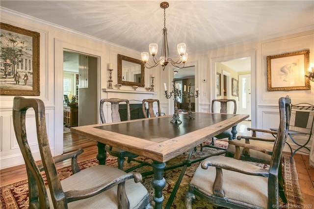 521 State St, Guilford, CT 06437 - dining room with a decorative wall, a chandelier, wood finished floors, and ornamental molding