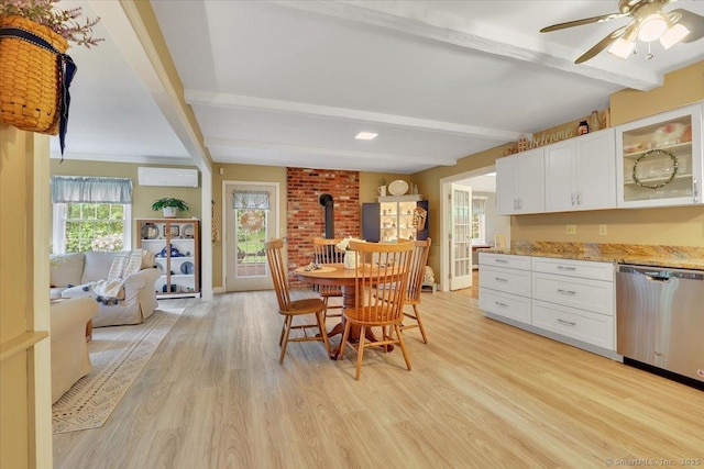 20 Thayer Road Ext, Haddam, CT 06441 - dining room with beam ceiling, an AC wall unit, light wood-type flooring, a wood stove, and a ceiling fan