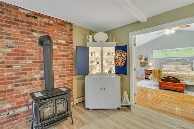 20 Thayer Road Ext, Haddam, CT 06441 - detailed view of a baseboard heating unit, wood finished floors, a wood stove, beamed ceiling, and ceiling fan