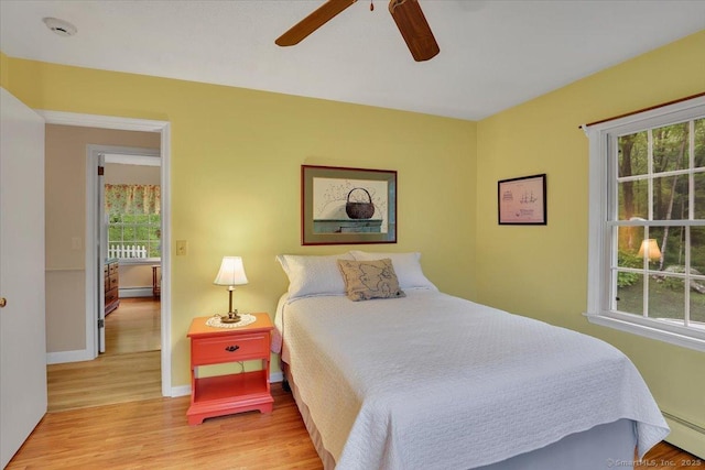 20 Thayer Road Ext, Haddam, CT 06441 - bedroom featuring a baseboard heating unit, wood finished floors, baseboards, and a ceiling fan