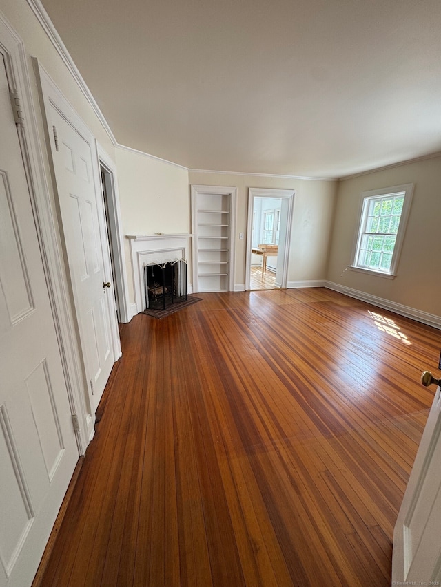 24 Saint Johns Pl Apt 6, New Canaan, CT 06840 - unfurnished living room featuring built in features, wood finished floors, a fireplace, and baseboards