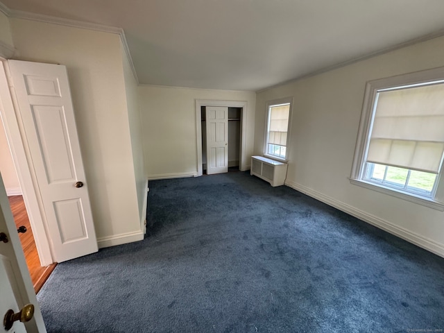 24 Saint Johns Pl Apt 6, New Canaan, CT 06840 - unfurnished bedroom featuring crown molding, dark colored carpet, baseboards, radiator heating unit, and a closet