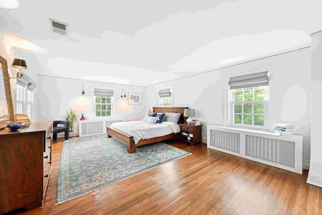 1050 King St, Greenwich, CT 06831 - bedroom with radiator heating unit and hardwood / wood-style flooring