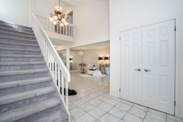 592 Mountain Rd Unit A, West Hartford, CT 06117 - stairway with a chandelier, high vaulted ceiling, and tile patterned floors