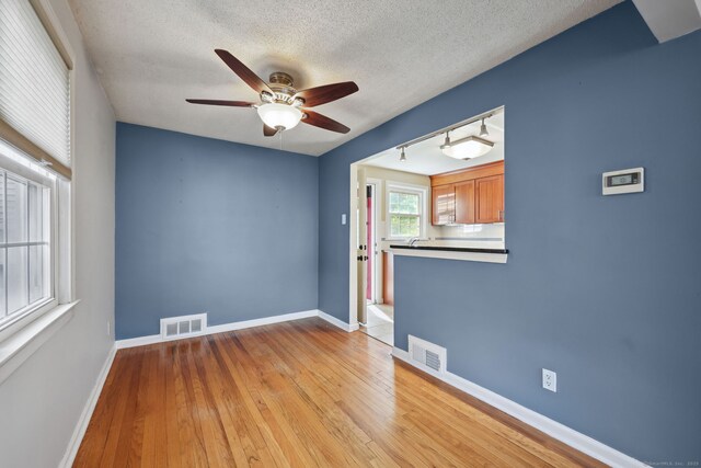 26 Brian Rd, West Hartford, CT 06110 - spare room featuring ceiling fan, light wood-style flooring, baseboards, and a textured ceiling