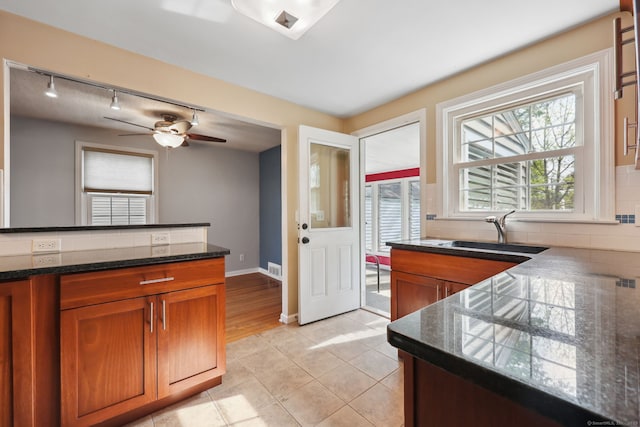 26 Brian Rd, West Hartford, CT 06110 - kitchen featuring a sink, rail lighting, brown cabinetry, and tasteful backsplash