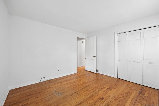 26 Brian Rd, West Hartford, CT 06110 - unfurnished bedroom featuring light wood-style floors, a closet, and baseboards
