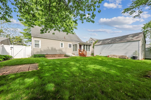 26 Brian Rd, West Hartford, CT 06110 - back of property featuring entry steps, a gate, and a sunroom