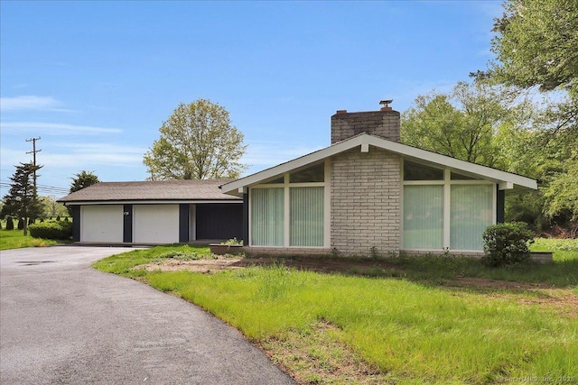1813 Peck Ln, Cheshire, CT 06410 - view of side of property featuring a chimney and a garage