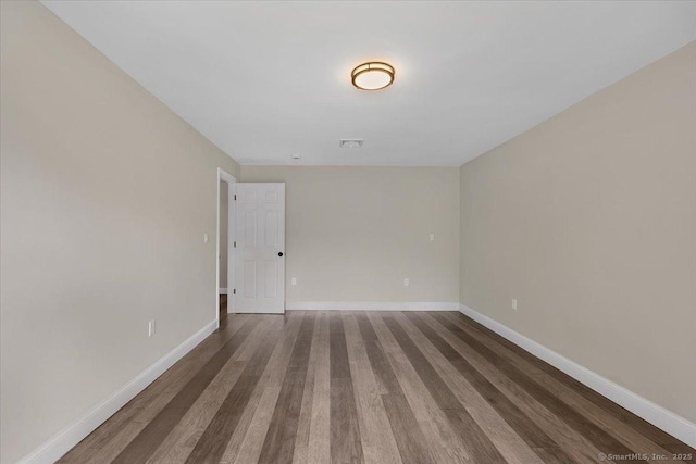 1813 Peck Ln, Cheshire, CT 06410 - empty room with dark wood-style flooring and baseboards